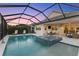 Inviting pool and spa area with a covered patio and plenty of seating at 883 Seascape Pl, Sarasota, FL 34240