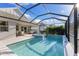 Lush landscaping surrounds this relaxing screened pool and spa at 883 Seascape Pl, Sarasota, FL 34240