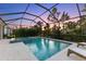 Relaxing pool and spa with screened enclosure at sunset at 883 Seascape Pl, Sarasota, FL 34240