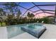 Luxury pool and spa with screened enclosure and lounge chairs at 883 Seascape Pl, Sarasota, FL 34240