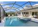 Resort-style pool and spa with covered patio and outdoor furniture at 883 Seascape Pl, Sarasota, FL 34240