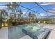 Relaxing screened pool and spa with tiled spa and plenty of lounge space at 883 Seascape Pl, Sarasota, FL 34240