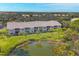 Aerial view of condo building near a pond at 8901 Veranda Way # 116, Sarasota, FL 34238