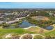 Aerial view of community near golf course and water at 8901 Veranda Way # 116, Sarasota, FL 34238