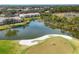 Aerial view of community, golf course, and lake at 8901 Veranda Way # 116, Sarasota, FL 34238