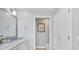 Modern bathroom with a marble vanity and access to a toilet and closet at 8901 Veranda Way # 116, Sarasota, FL 34238