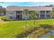 Building exterior with pond view and lush landscaping at 8901 Veranda Way # 116, Sarasota, FL 34238