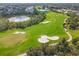 Aerial view of a lush golf course with strategically placed sand traps at 8901 Veranda Way # 116, Sarasota, FL 34238