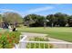 Golfers enjoying a sunny day on the putting green at 8901 Veranda Way # 116, Sarasota, FL 34238