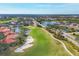 Aerial view of a golf course with homes and water features at 8901 Veranda Way # 116, Sarasota, FL 34238