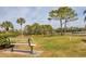 Relaxing park bench overlooking a pond and lush landscape at 8901 Veranda Way # 116, Sarasota, FL 34238