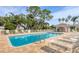 Community pool with a pool house and lounge chairs at 8901 Veranda Way # 116, Sarasota, FL 34238