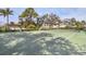 Well-maintained tennis court surrounded by trees and landscaping at 8901 Veranda Way # 116, Sarasota, FL 34238