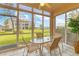 Sunroom with glass walls, table, and chairs at 9620 Club South Cir # 5102, Sarasota, FL 34238