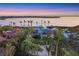 Aerial view of waterfront home with lush landscaping and private dock at 10106 46Th W Ave, Bradenton, FL 34210
