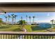 Waterfront backyard with palm trees, grassy lawn, and a pathway at 10106 46Th W Ave, Bradenton, FL 34210
