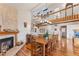Bright dining room features hardwood floors, a large wooden table, and a fireplace at 10106 46Th W Ave, Bradenton, FL 34210