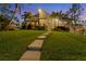 Two-story home with walkway leading to entrance, surrounded by palm trees at 10106 46Th W Ave, Bradenton, FL 34210