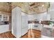 Spacious kitchen boasting white cabinets, granite counters, and a tin ceiling at 10106 46Th W Ave, Bradenton, FL 34210