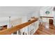 Upstairs hallway with wooden railing and hardwood floors at 10106 46Th W Ave, Bradenton, FL 34210
