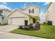 Two-story house with a two-car garage and manicured lawn at 10210 Mangrove Well Rd, Sun City Center, FL 33573