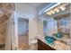 Elegant bathroom with granite vanity, glass sink, and tile shower at 10523 Cheval Pl, Lakewood Ranch, FL 34202
