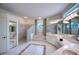 Large bathroom with glass block shower, double sinks, and a soaking tub at 10523 Cheval Pl, Lakewood Ranch, FL 34202