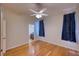 Bedroom with hardwood floors, ceiling fan, and en-suite bathroom at 10523 Cheval Pl, Lakewood Ranch, FL 34202