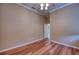Simple bedroom with wood flooring and ceiling fan at 10523 Cheval Pl, Lakewood Ranch, FL 34202