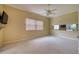 Spacious bedroom with ceiling fan, carpeting, and large window at 10523 Cheval Pl, Lakewood Ranch, FL 34202