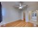 Bright bedroom with wood flooring, ceiling fan, and ample closet space at 10523 Cheval Pl, Lakewood Ranch, FL 34202