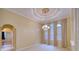 Bright dining room with high ceilings, chandelier, and access to the kitchen at 10523 Cheval Pl, Lakewood Ranch, FL 34202
