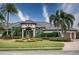 Beautiful one-story home with tile roof, fountain, and lush landscaping at 10523 Cheval Pl, Lakewood Ranch, FL 34202