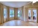 Bright Gathering room with hardwood floors, sliding doors to the pool area, and large windows at 10523 Cheval Pl, Lakewood Ranch, FL 34202