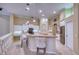 Modern kitchen with granite counters, island, and stainless steel appliances at 10523 Cheval Pl, Lakewood Ranch, FL 34202