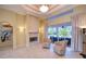 Elegant living room with a fireplace, high ceilings, and access to the pool area at 10523 Cheval Pl, Lakewood Ranch, FL 34202