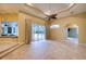 Open living area with tile floors, access to pool and lanai at 10523 Cheval Pl, Lakewood Ranch, FL 34202