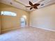 Spacious living room with tile flooring and views to the backyard at 10523 Cheval Pl, Lakewood Ranch, FL 34202
