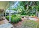 Landscaped backyard with fire pit and screened patio at 1101 Anclote Blvd, Tarpon Springs, FL 34689
