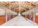 Long barn aisle with multiple horse stalls and tack at 1101 Anclote Blvd, Tarpon Springs, FL 34689