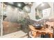 Rustic bathroom with a unique stone shower and sink at 1101 Anclote Blvd, Tarpon Springs, FL 34689