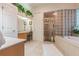 Elegant bathroom with a soaking tub, shower, and double vanity at 1101 Anclote Blvd, Tarpon Springs, FL 34689