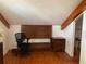 Simple bedroom with wood flooring and a dresser at 1101 Anclote Blvd, Tarpon Springs, FL 34689