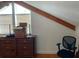 Cozy bedroom with wood beams, dresser, and office chair at 1101 Anclote Blvd, Tarpon Springs, FL 34689