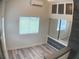 Bright bedroom with wood-look floors, window, and built-in storage at 1101 Anclote Blvd, Tarpon Springs, FL 34689