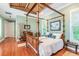 Main bedroom with hardwood floors and a four-poster bed at 1101 Anclote Blvd, Tarpon Springs, FL 34689