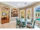 Bright breakfast nook with glass table and seating for four, overlooking the pool at 1101 Anclote Blvd, Tarpon Springs, FL 34689
