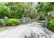 Private gated entrance with stone pillars and landscaping at 1101 Anclote Blvd, Tarpon Springs, FL 34689
