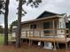 House with a large wooden deck and AC unit at 1101 Anclote Blvd, Tarpon Springs, FL 34689