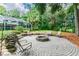 Circular fire pit with seating area in the backyard at 1101 Anclote Blvd, Tarpon Springs, FL 34689